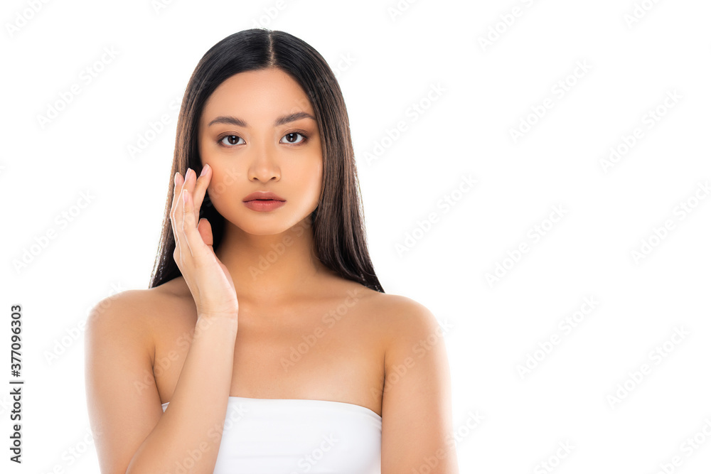 Asian woman looking at camera and touching face isolated on white Asian woman looking at camera and touching face isolated on white