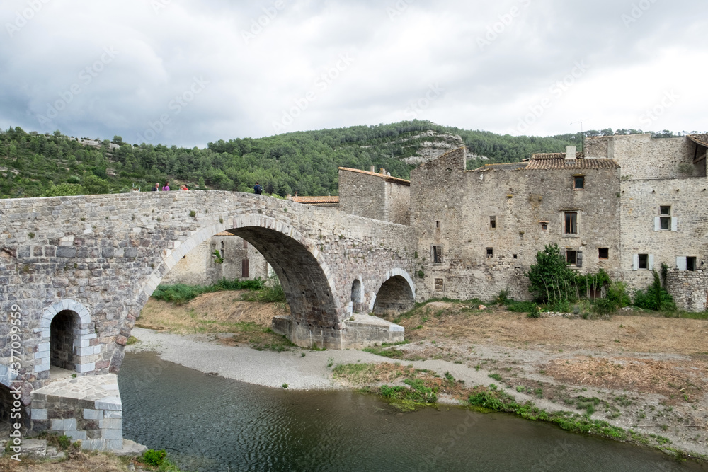 The old historical architecture including the famous bridge across the small mountain river in medieval village Lagrasse, the most beautiful village of France. 