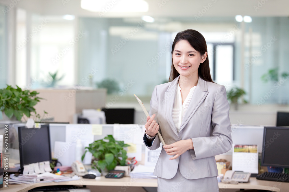 Cheerful office lady with a file in office Cheerful office lady with a file in office