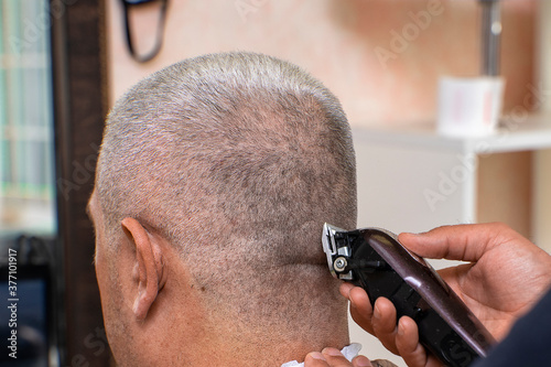 the process of clipping a gray-haired man