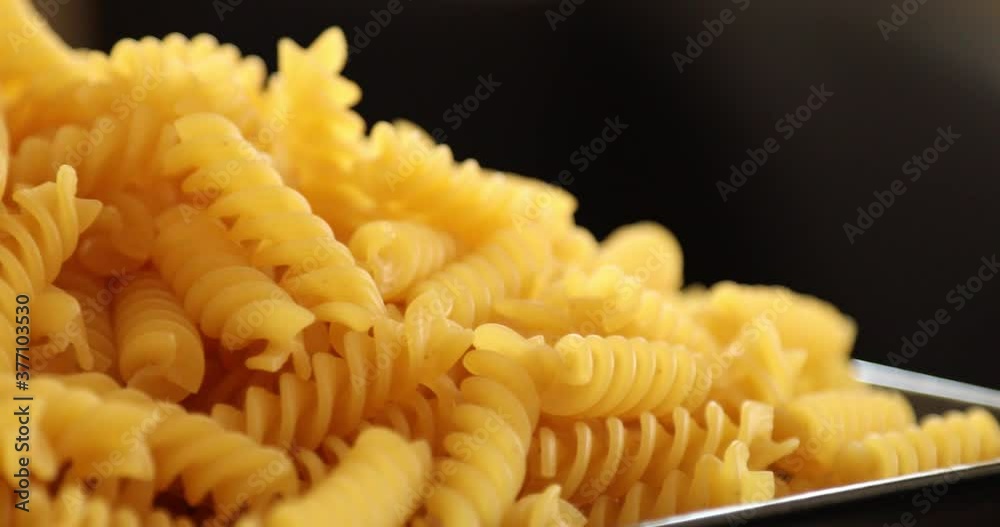 Heap of rotating fusilli pasta on plate closeup Heap of rotating fusilli pasta on plate closeup