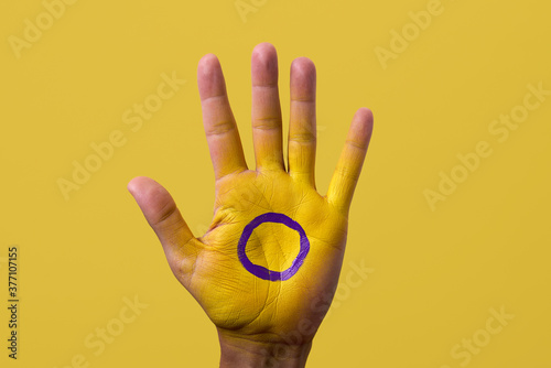 the intersex flag in the palm of the hand