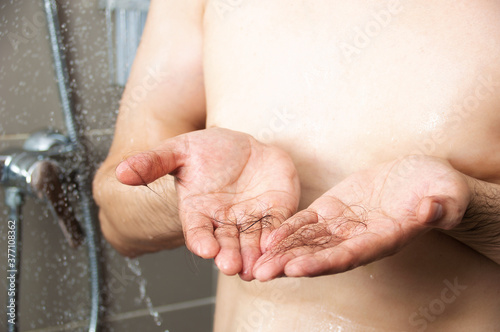 Close-up of a hands with hair from falling in the shower