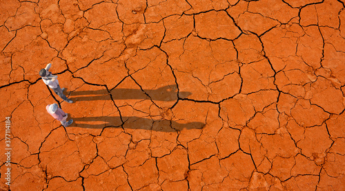 Two people on a dried up soil