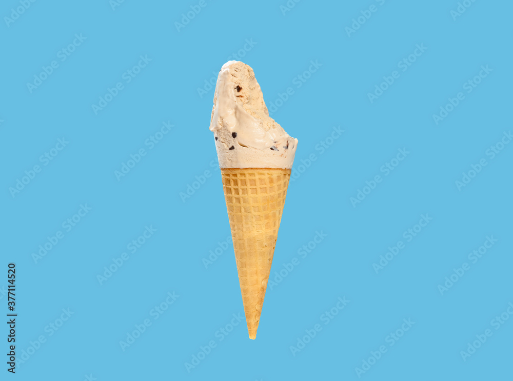 milk tea flavor ice cream cone with couple of bites on a blue background horizontal composition milk tea flavor ice cream cone with couple of bites on a blue background horizontal composition