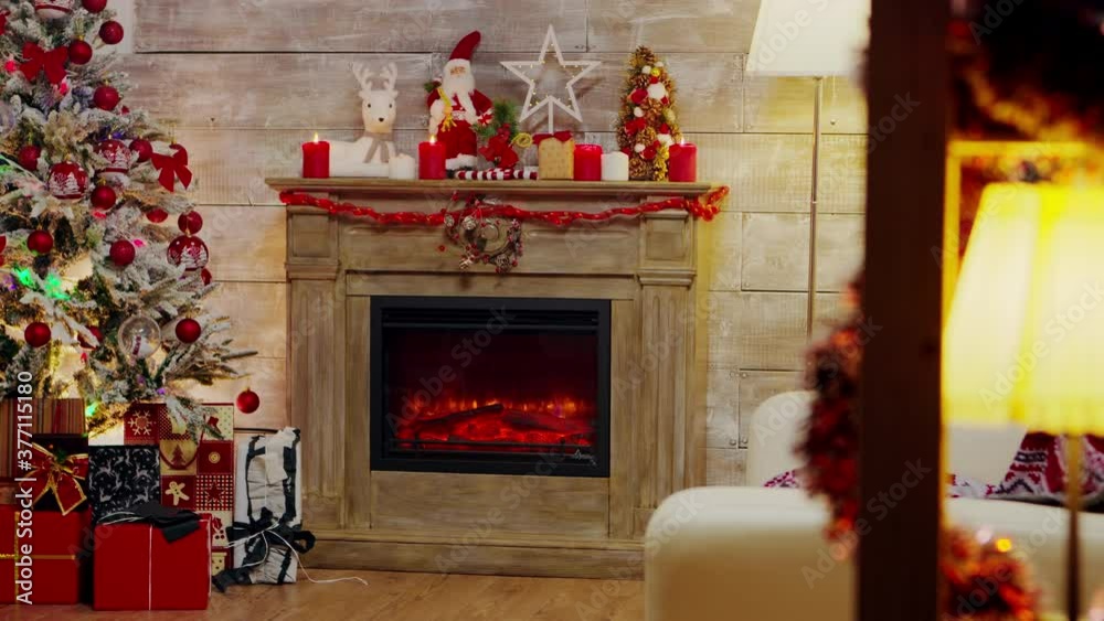 Presents under a christmas tree with lights and fireplace burning. Presents under a christmas tree with lights and fireplace burning.