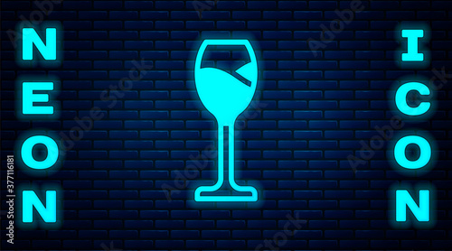 Glowing neon Wine glass icon isolated on brick wall background. Wineglass icon. Goblet symbol. Glassware sign. Happy Easter. Vector.