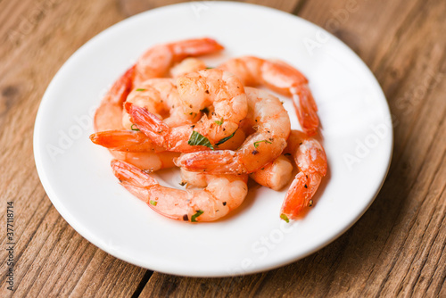 Shrimp grilled delicious seasoning spices on white plate wooden background - appetizing cooked shrimps baked prawns , Seafood shelfish