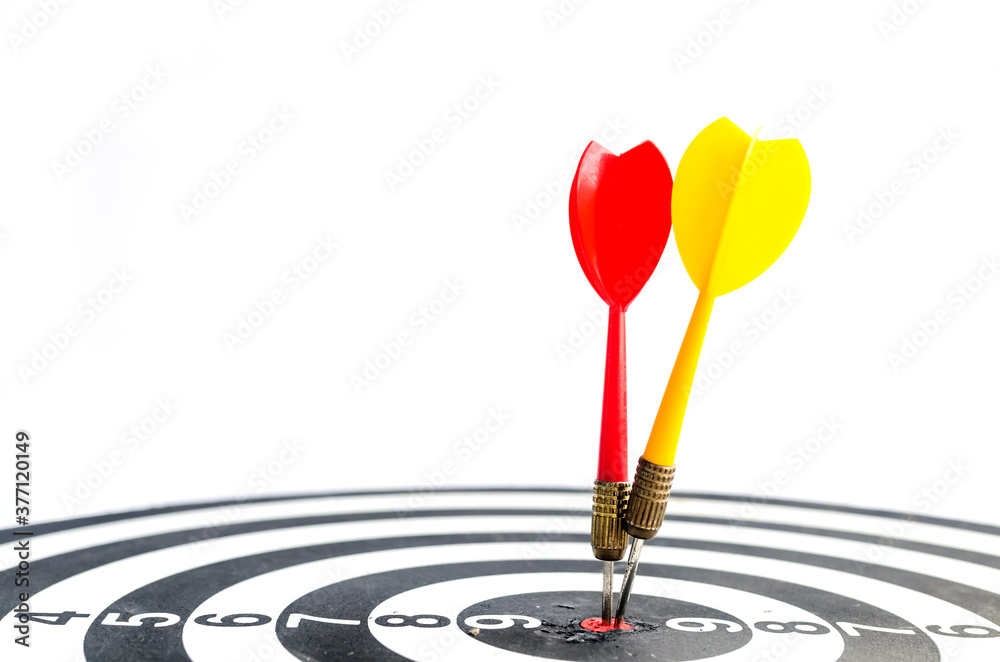 Target hit in the center by arrow. Success goals Targeting the business concept. Close up shot red dart arrow on center of dartboard, isolated on white background with clipping path. Target hit in the center by arrow. Success goals Targeting the business concept. Close up shot red dart arrow on center of dartboard, isolated on white background with clipping path.