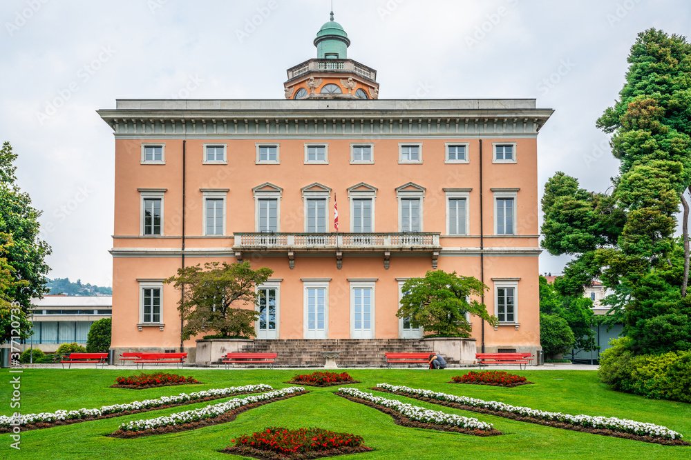 Historic orange Villa Ciani front view in Parco Civico public garden in Lugano Switzerland