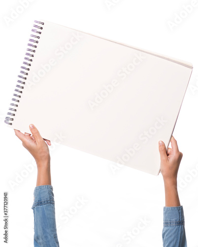 child's hands holding a drawing block