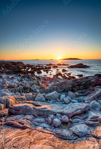Sunset over the rocky beach at Mealista