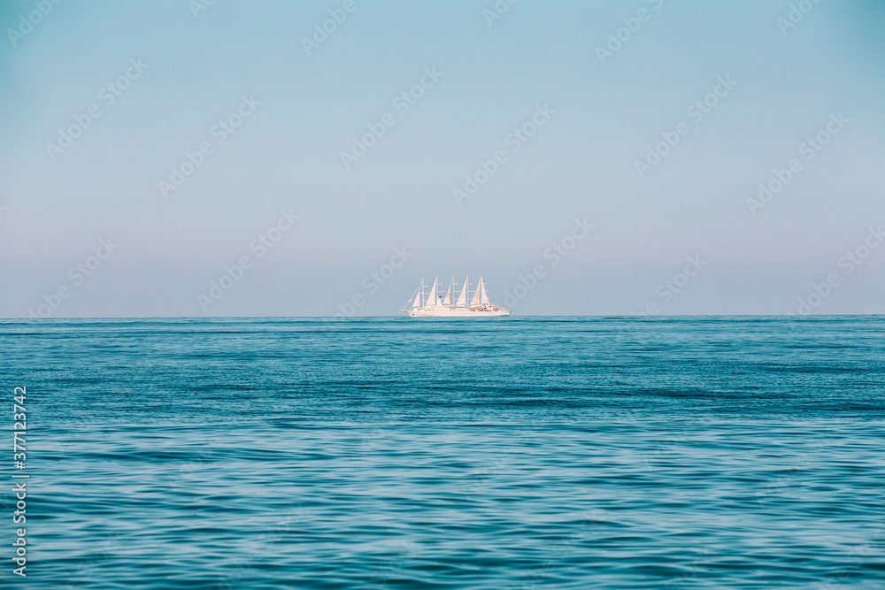 Modern Sail Ship at Sea Ocean On Horizon