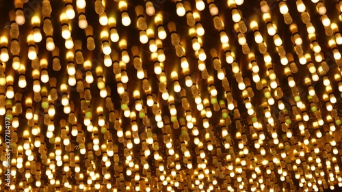 Old fasioned electric lamps blinking and glowing at night. Abstract close up of retro casino decoration shimmering in Las Vegas, USA. Illuminated vintage style bulbs glittering on Freemont street
