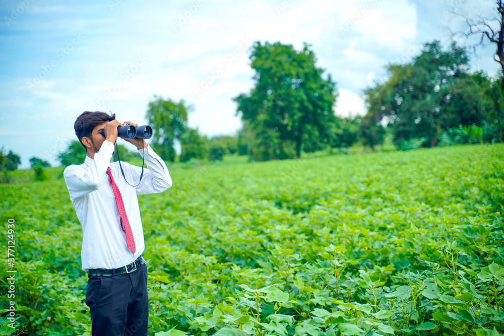 Indian man enjoys in nature with binoculars Indian man enjoys in nature with binoculars