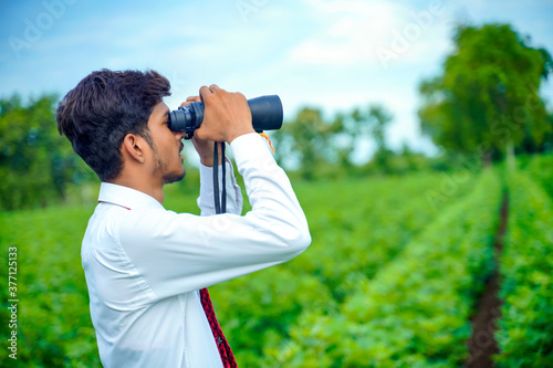 Indian man enjoys in nature with binoculars