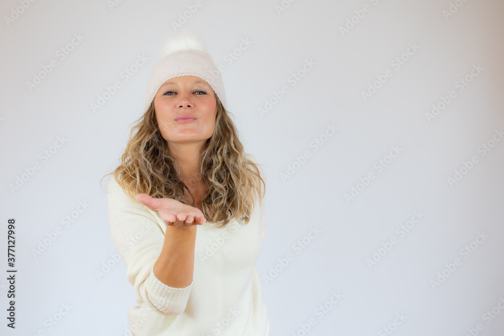 Beautiful woman in winter clothes sending a kiss Beautiful woman in winter clothes sending a kiss
