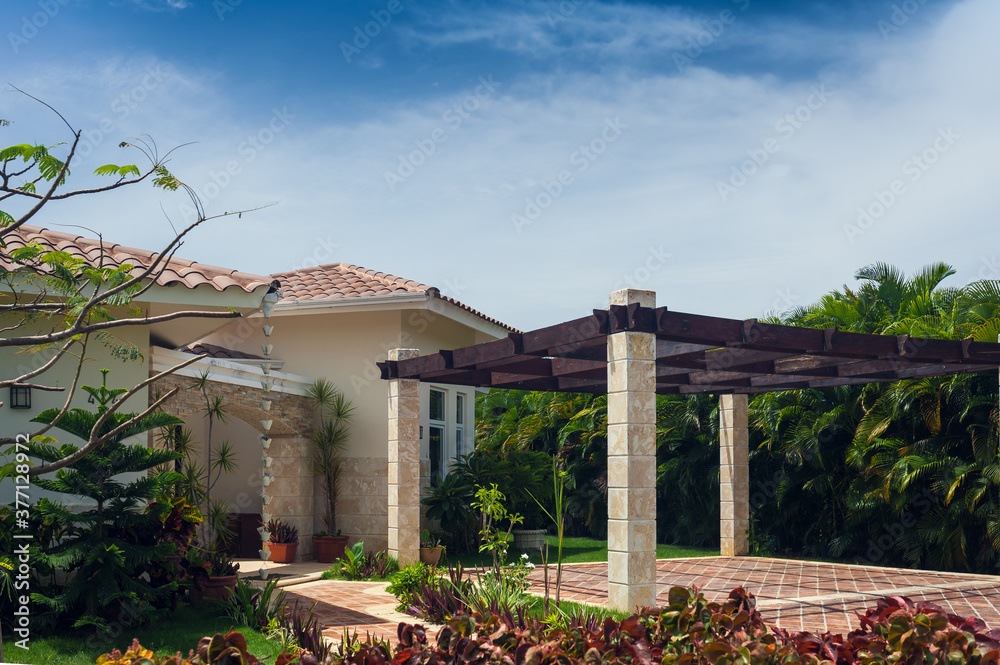 Fototapeta premium Beautiful Luxurious villa with an own swimming pool in Dominican Republic. summer residence on luxury Caribbean resort and beautiful garden.