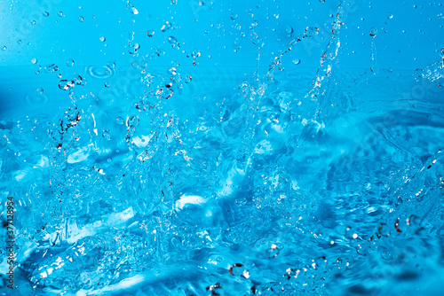 splash of water on a blue background. Abstract wallpaper