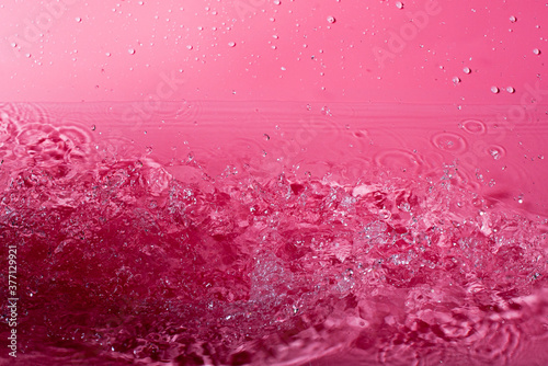 splash of water on a red background. Abstract wallpaper