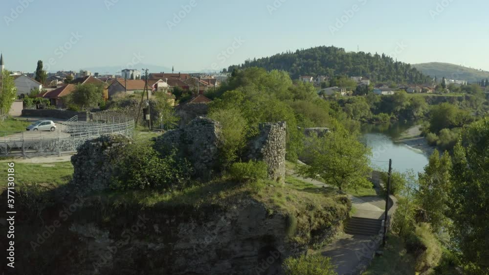Aerial shot Montenegro Podgorica. A beautiful drone flying over the walls of an old fortress that stands in the city in the middle of buildings and streets. Aerial shot Montenegro Podgorica. A beautiful drone flying over the walls of an old fortress that stands in the city in the middle of buildings and streets.