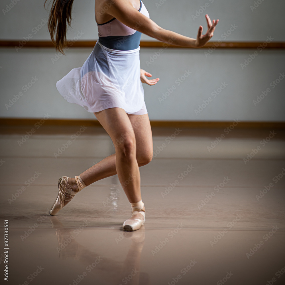 Fototapeta premium Legs and slippers of classical ballet dancers rehearsing