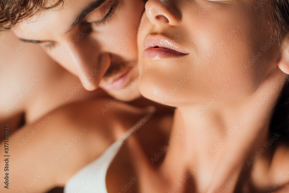 Selective focus of shirtless man standing near young girlfriend Selective focus of shirtless man standing near young girlfriend