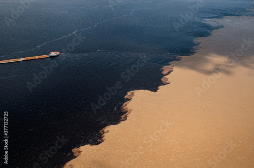 Vista aerea do Encontro das Águas, fenômeno que acontece na confluência entre o rio Negro, de água escura, e o rio Solimões clara.. photo