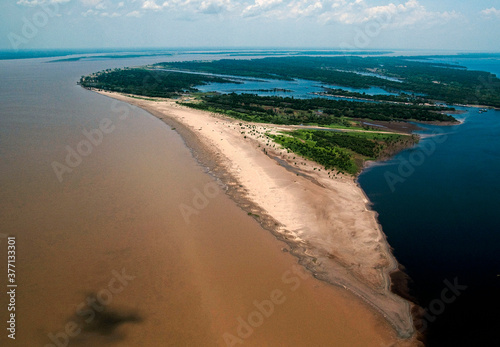 Vista aerea do Encontro das Águas, fenômeno que acontece na confluência do rio Negro, de água escura à direita, com o rio Solimões à esquerda.. photo