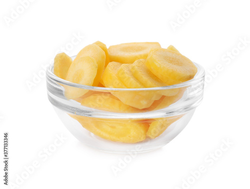 Slices of raw yellow carrot in glass bowl isolated on white