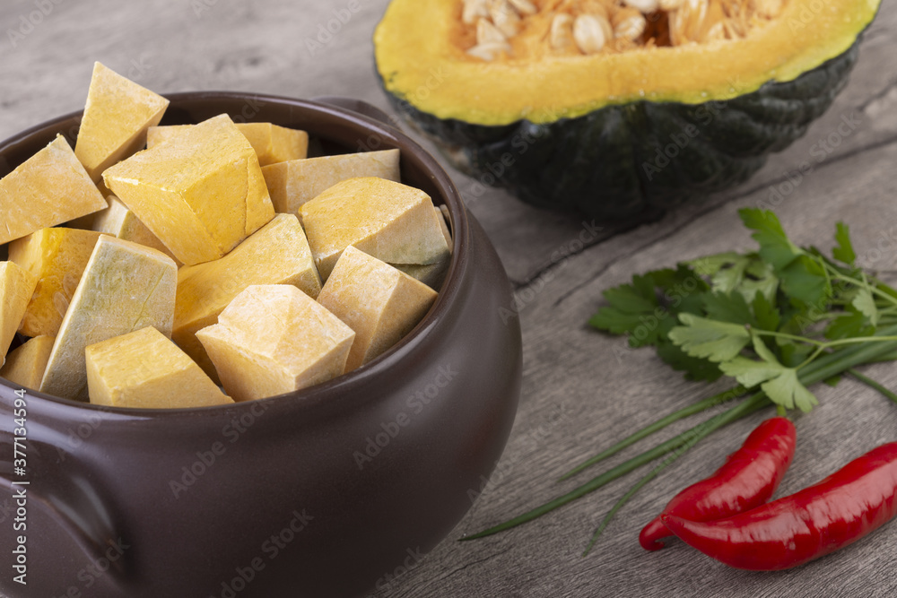 Kabocha pieces on a bowl with half fruit Kabocha pieces on a bowl with half fruit