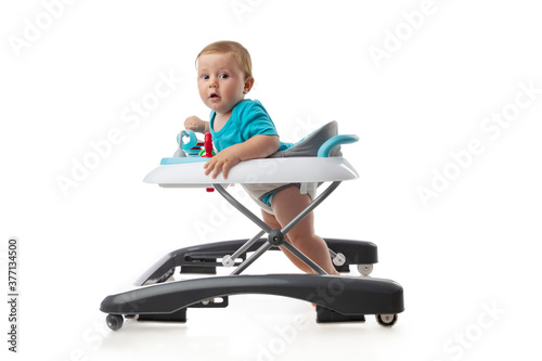 фотографія Baby and baby walker with  toys isolated on white