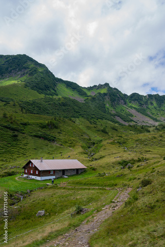 Great and Beautiful hike on the Hohe Ifen in the Kleinwalsertal in the Allgau Alps. Mountain hut with hikers.