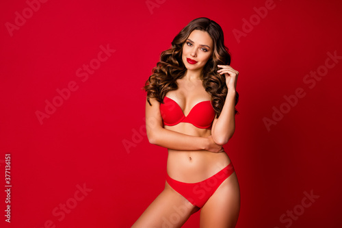 Photo of attractive seduce perfect beauty curly lady advertising underwear novelty sensual slim fit body bright pomade wear brassiere panties isolated vivid red color background