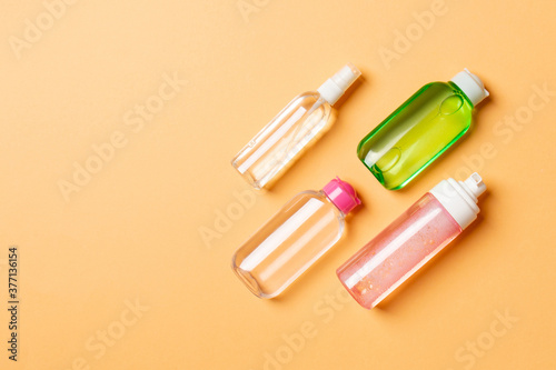Cosmetics SPA branding mock-up, top view with copy space. set of tubes and jars of cream flat lay on colored background