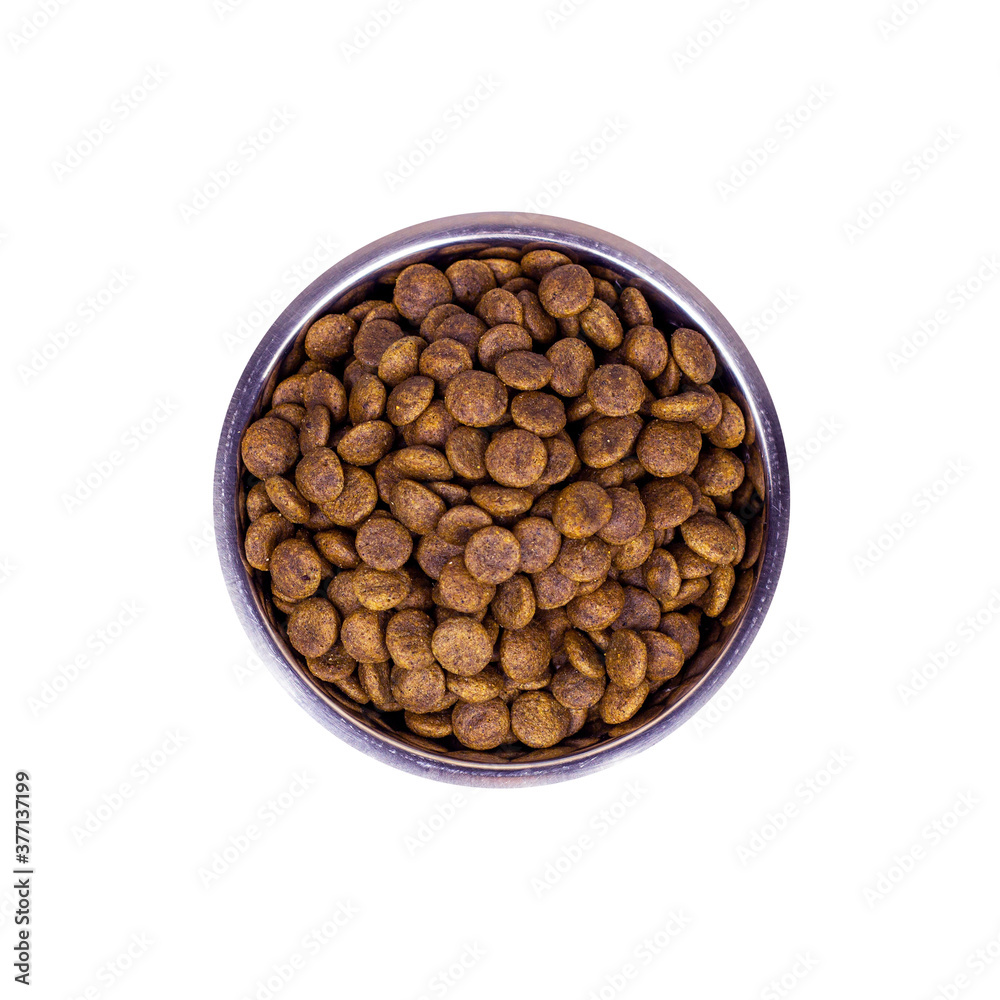 Top view of brown biscuit bones and crunchy organic kibble pieces for dog feed in a metal bowl isolated on white background. Healthy dry pet food concept. Top view of brown biscuit bones and crunchy organic kibble pieces for dog feed in a metal bowl isolated on white background. Healthy dry pet food concept.