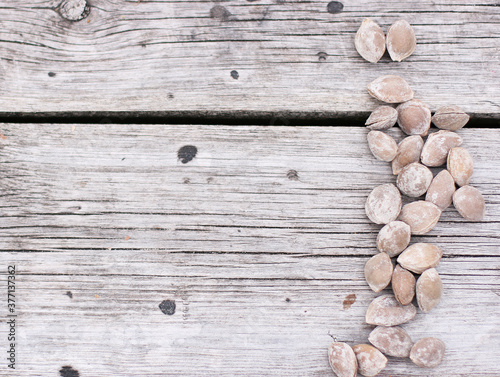 Apricot nuts wooden background. Top view with copyspace. Flat lay with nuts