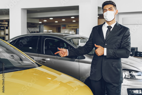 Man car dealer wearing protective medical mask on his working place © fotofabrika