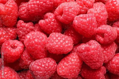 Fresh sweet ripe raspberries as background, closeup