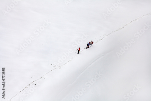trekking in baltoro glaciers , Karakorum range Pakistan, hikers are walking in line at snow lake in pakistan  photo