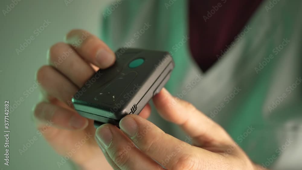 80s 90s vintage pager beeper being used by a doctor or nurse wearing a