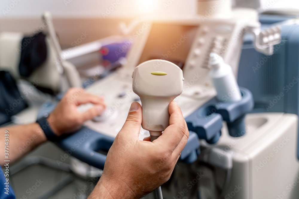 Ultrasonography (USG). Hand holding ultrasound probe and coupling gel