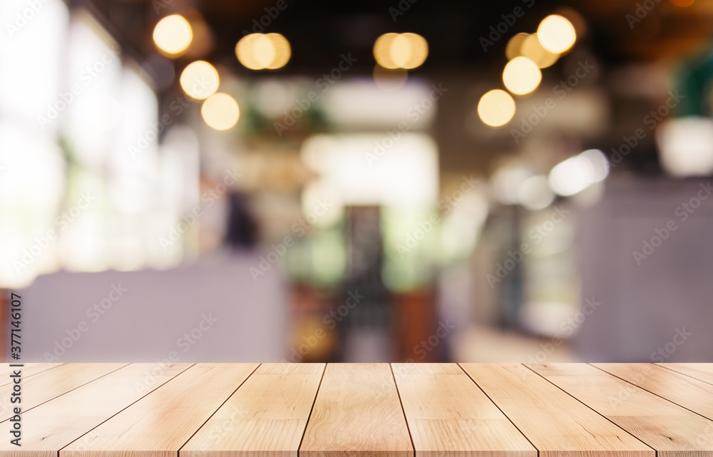 Empty wooden table top with lights bokeh on blur restaurant background Empty wooden table top with lights bokeh on blur restaurant background