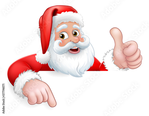 Santa Claus Christmas cartoon character peeking over a sign giving a thumbs up and pointing.