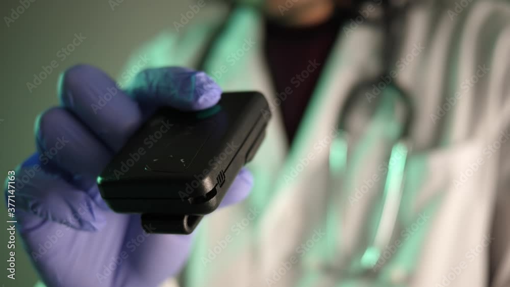 80s 90s vintage pager beeper being used by a doctor or nurse wearing a