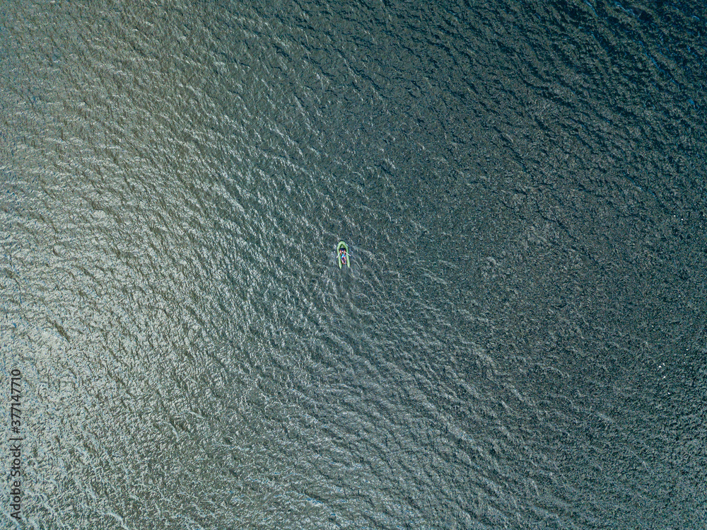 Aerial drone view. Fishing boat on the waves of the river. Aerial drone view. Fishing boat on the waves of the river.