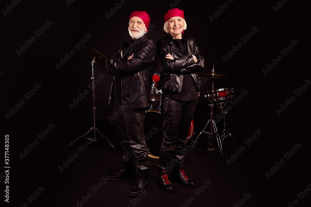 Full length photo of two pensioners family cool aged lady man rock group all life together concert show drum instruments wear trendy rocker leather outfit isolated black color background