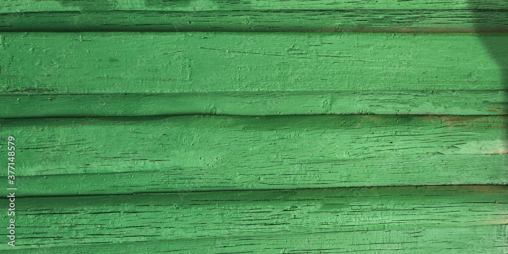 Green wooden fence, close up. Background surface Green wooden fence, close up. Background surface