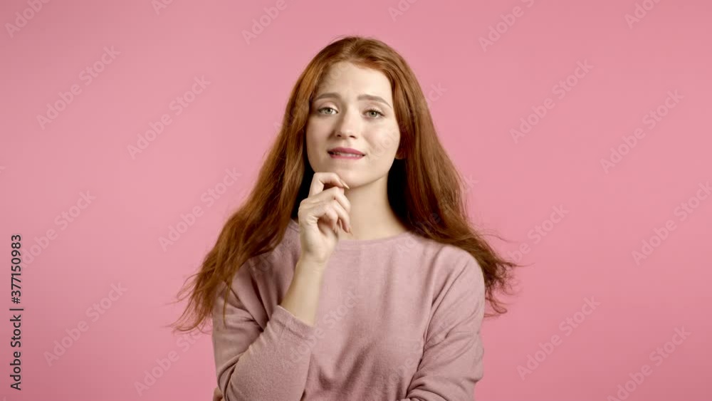 Thinking woman looking up and around on pink background. Happy smiling face expressions. Pretty model with attractive appearance. Thinking woman looking up and around on pink background. Happy smiling face expressions. Pretty model with attractive appearance.