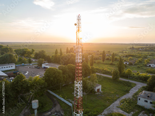 Aerial drone view. Cellular relay tower at sunset.
